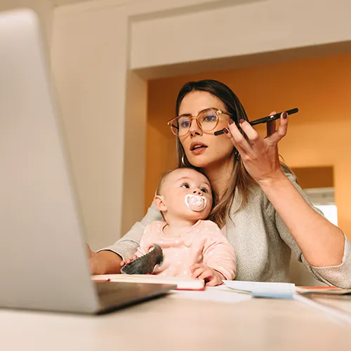 493417678 Mother using computer while talking on the phone