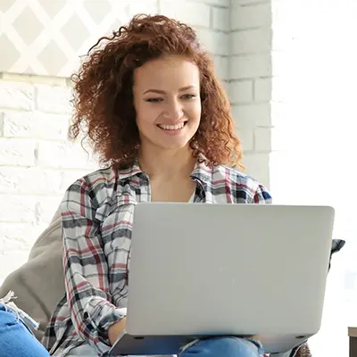 Woman using a laptop.