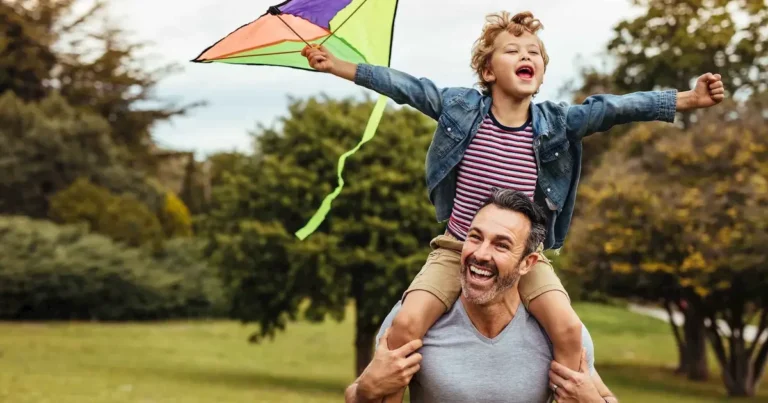 Man and boy playing with a kite