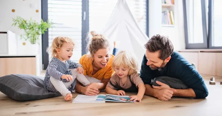 Happy family reading on the floor