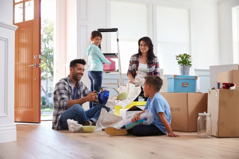 Happy family surrounded by moving boxes